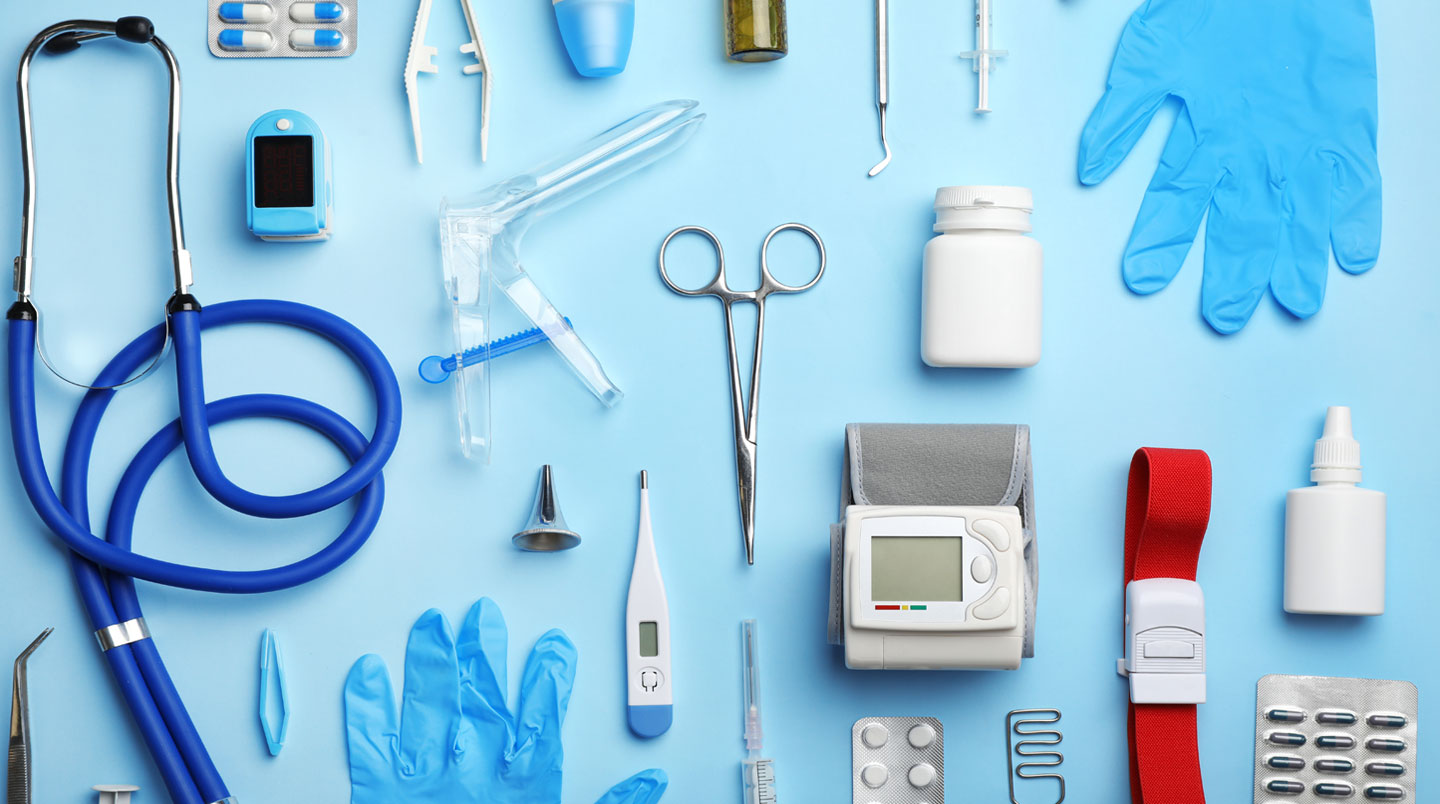 Mallette de soins médicaux posée sur une table blanche avec stéthoscope et matériel dentaire léger en fond flou.